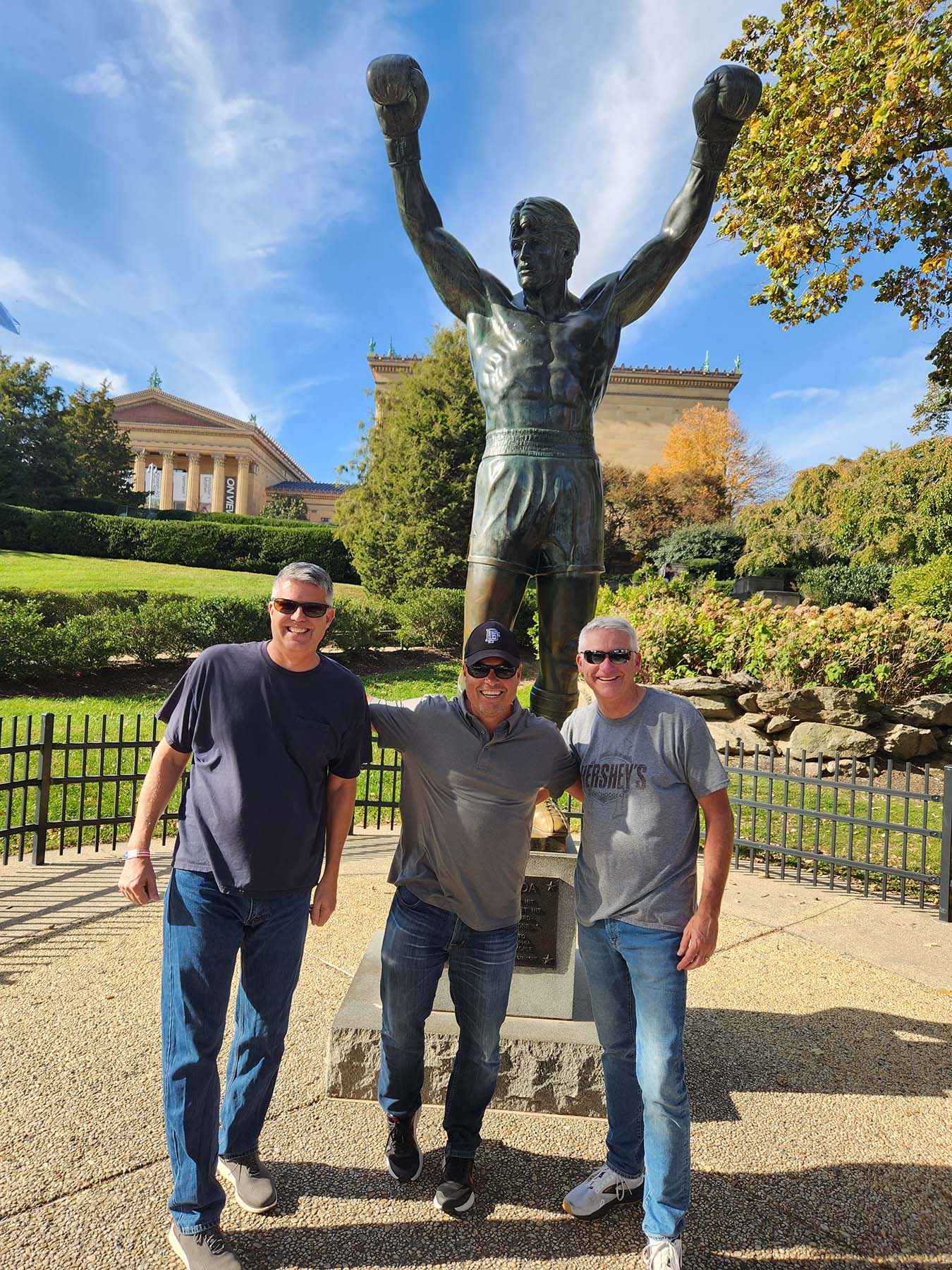 The team posing in front of the Rocky statue in Philadelphia representing long-term friendships, shared experiences, retirement lifestyle travel, and enjoying meaningful moments together