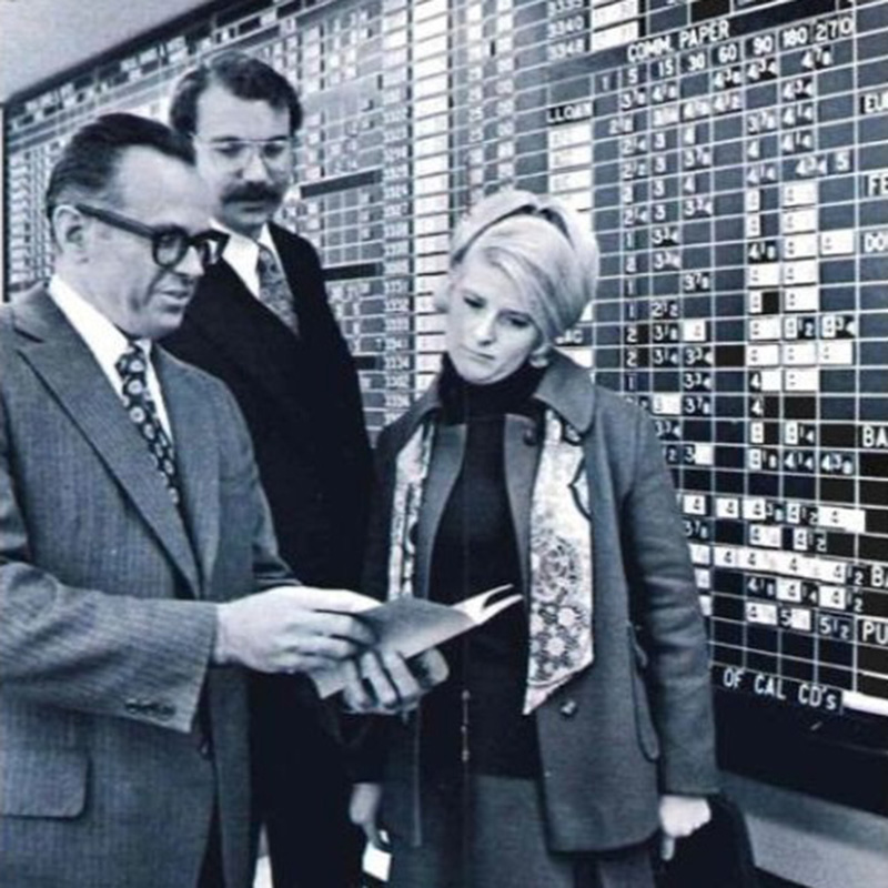 Vintage financial professionals reviewing market information representing industry heritage, long-term expertise, financial planning history, and trusted advisory traditions