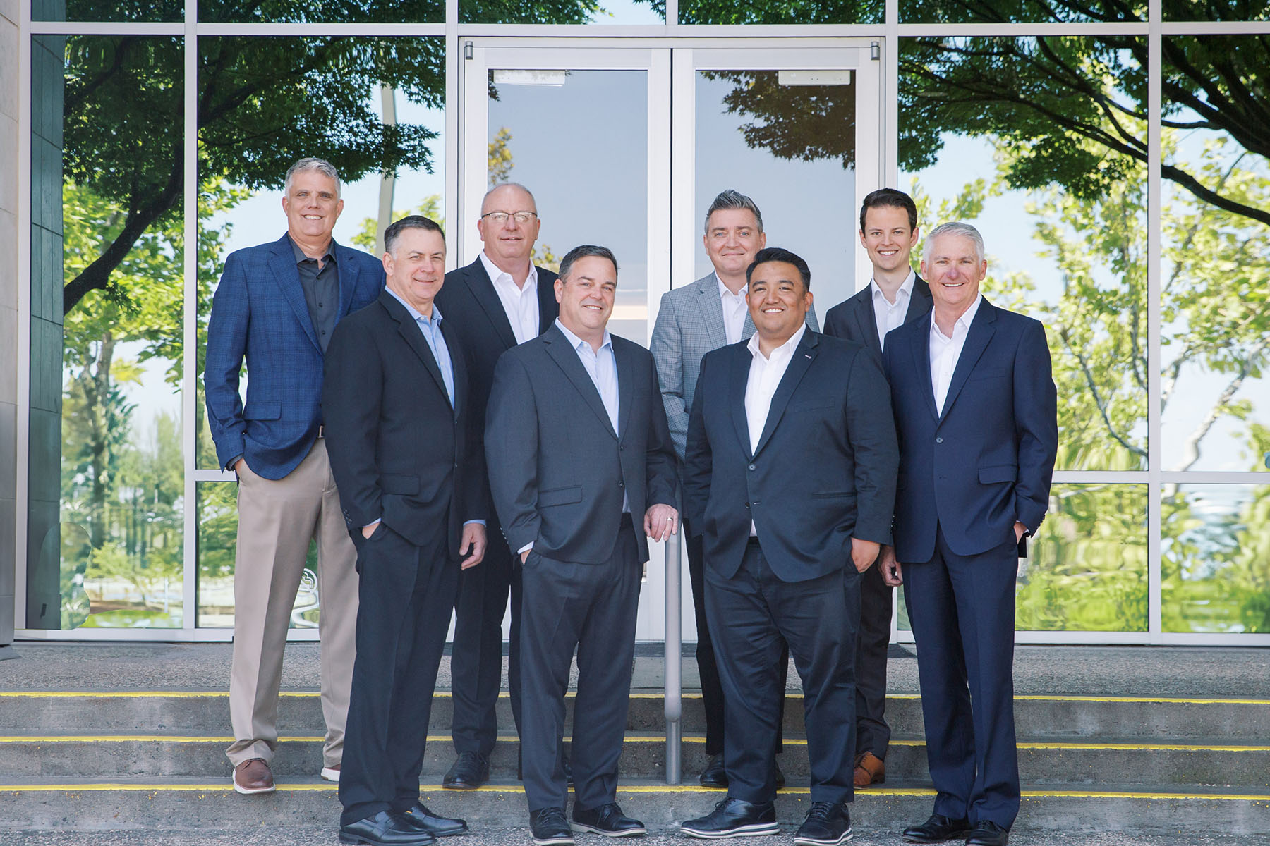 Group portrait of the Bluespring Wealth California advisory team standing outside the office building