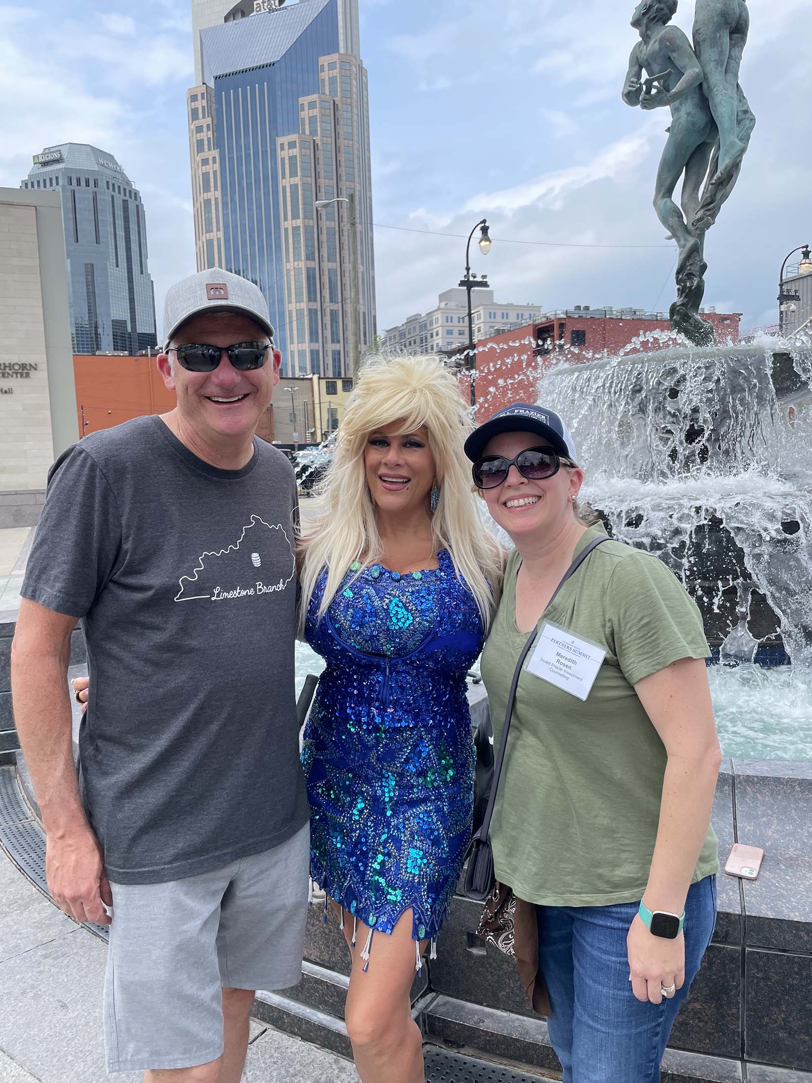 Couple posing with entertainer in downtown city setting representing lifestyle experiences, community involvement, travel memories, and enjoying retirement with confidence