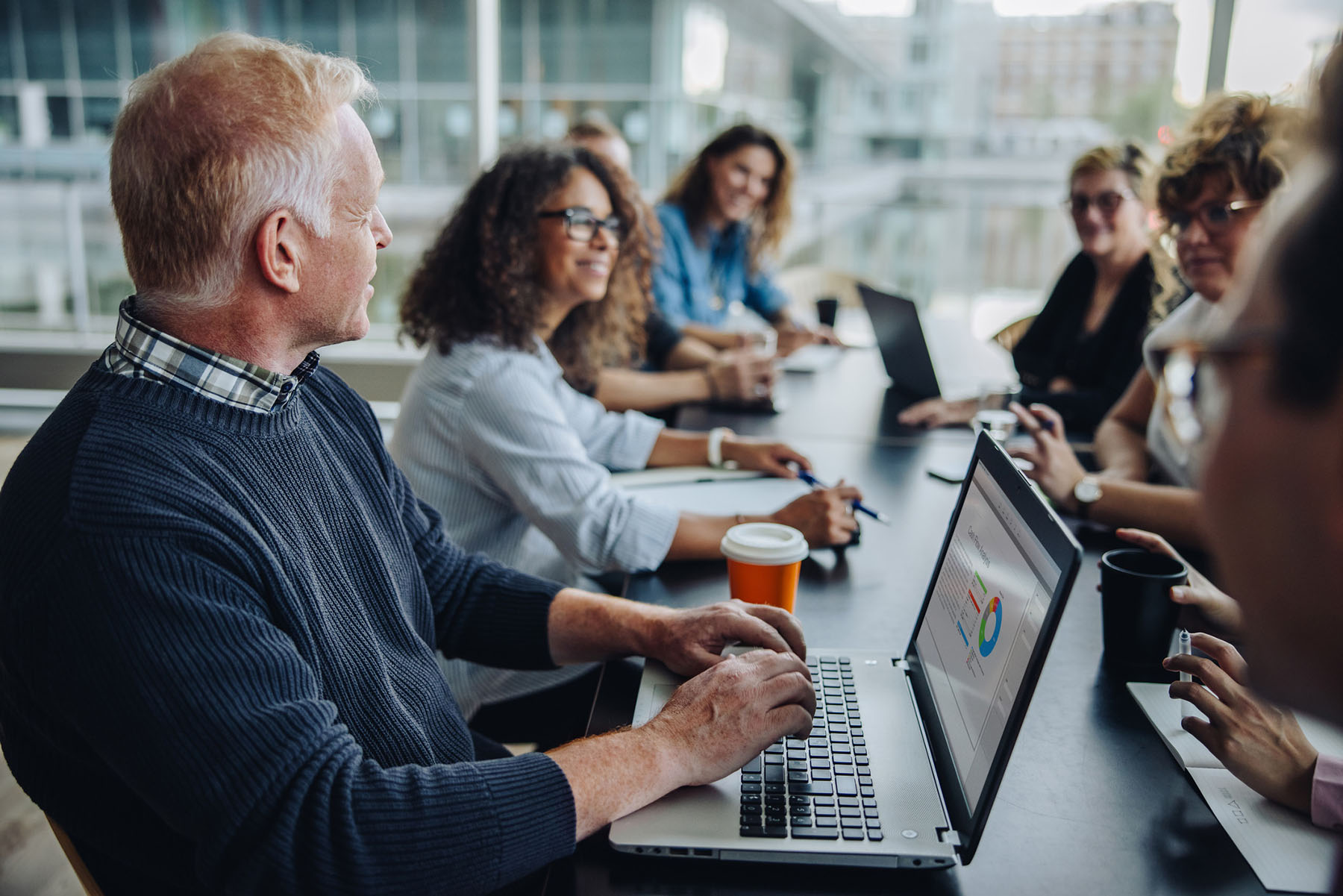 Business team collaborating in conference room representing strategic financial planning, professional advisory teamwork, business consulting services, and collaborative decision-making